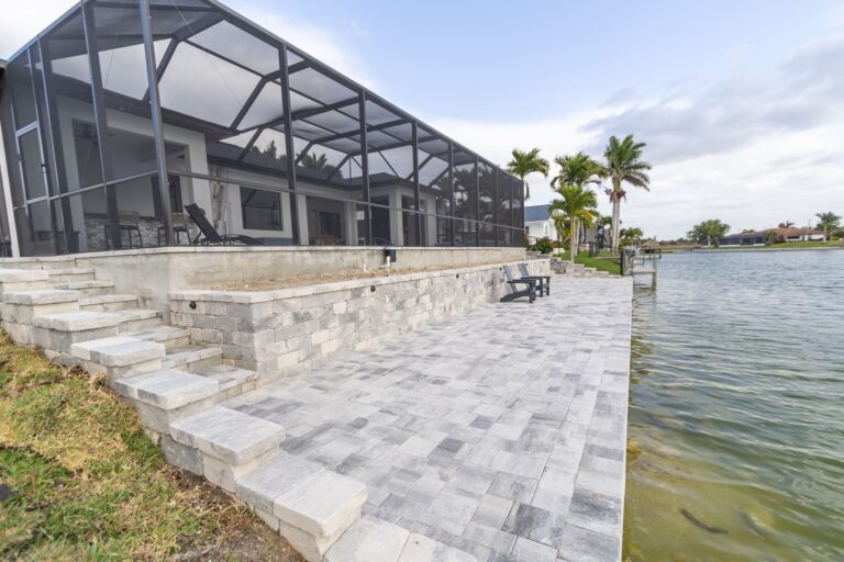 Waterfront paver patio, retaining wall and steps installed by NativeScapes