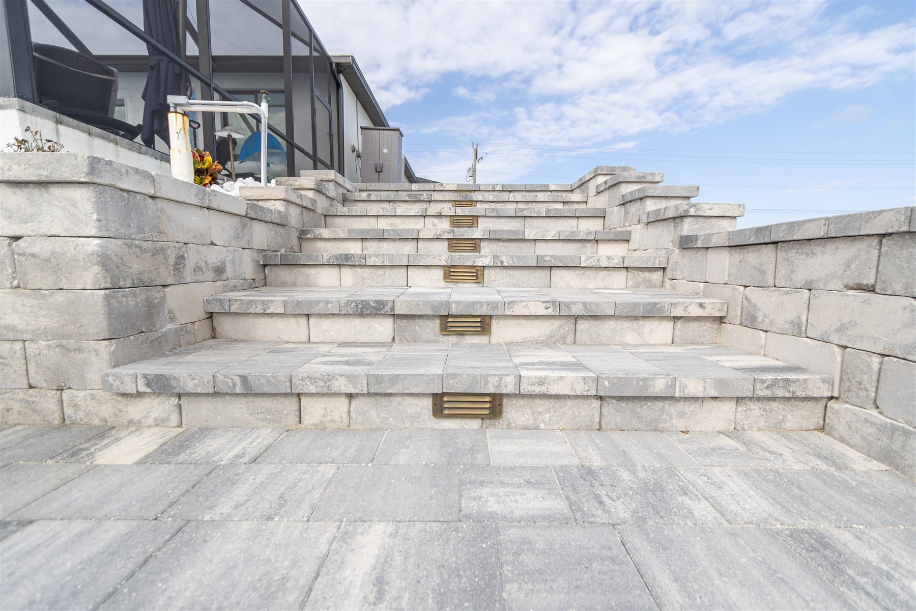 Illuminated paver steps and retaining walls on a completed Captain’s Walk by NativeScapes