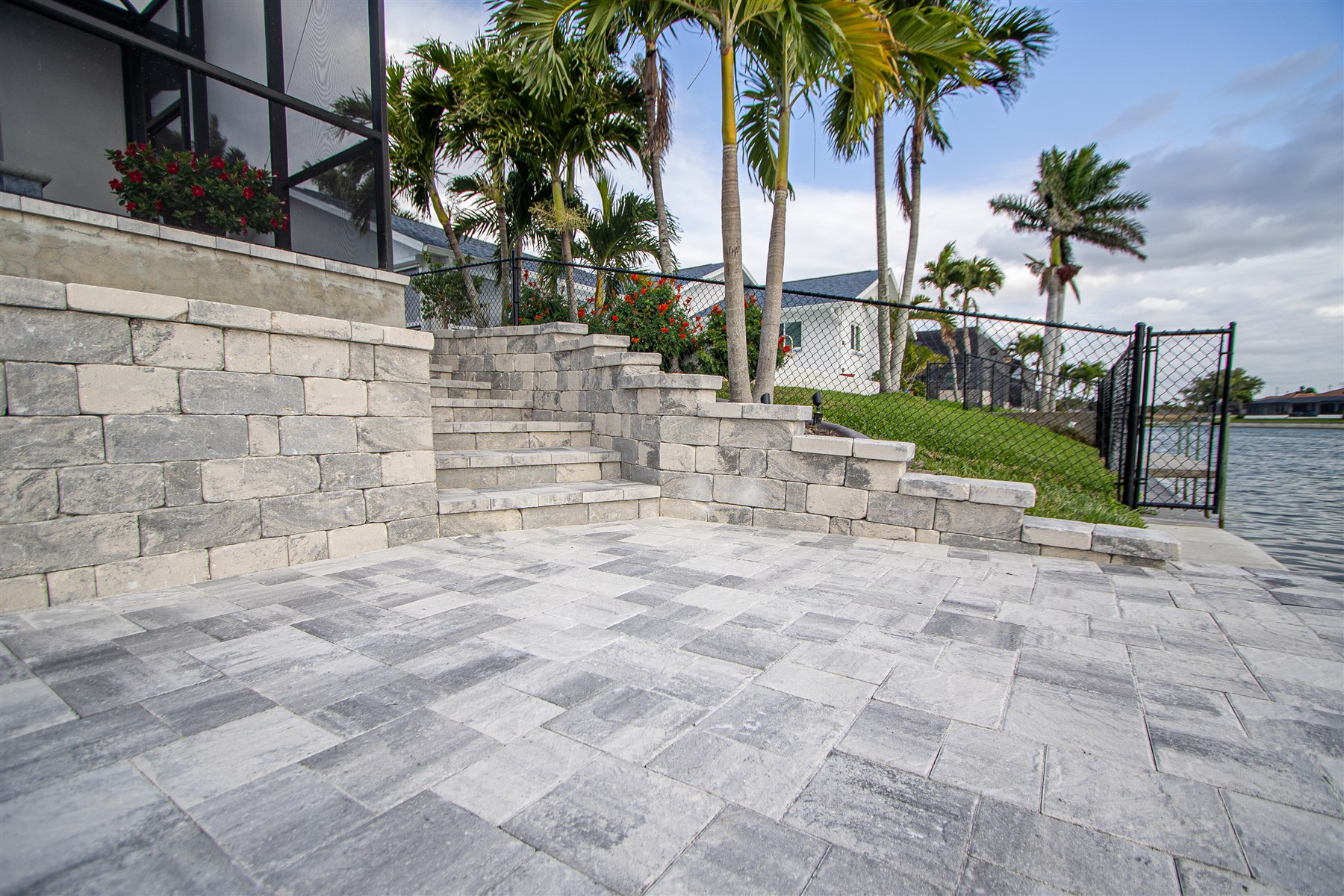Completed Captain’s Walk paver patio with retaining walls and waterfront access by NativeScapes in Southwest Florida